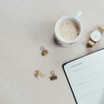 white printer paper beside filled mug