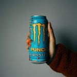 person holding blue and orange can