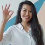 Woman making an ok sign with her hand.