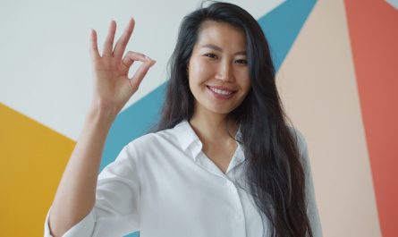 Woman making an ok sign with her hand.